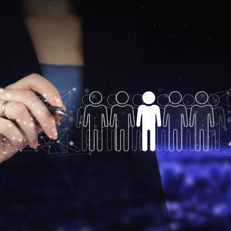 hr-human-resources-peoples-relation-organisation-structure-hand-holding-digital-graphic-pen-drawing-digital-hologram-human-leader-sign-city-dark-blurred-background (1)